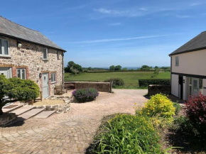 The Granary at Pentregaer Ucha, tennis court & lake.